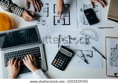 Close up of hands working brainstorming and measuring for cost estimating on paperworks and floor plan drawings about design architectural and engineering for houses and buildings.