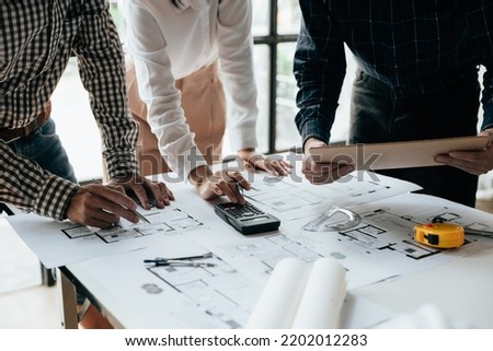 Close up of hands working brainstorming and measuring for cost estimating on paperworks and floor plan drawings about design architectural and engineering for houses and buildings.