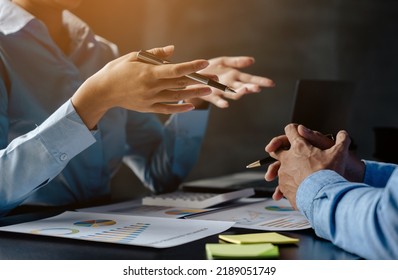 Close up of hands are working and brainstorming on paperworks about business financial and marketing with ray light. - Shutterstock ID 2189051749