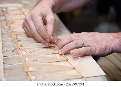 Close Up Of Hands Working On Balsa Wood Model Plane Wing