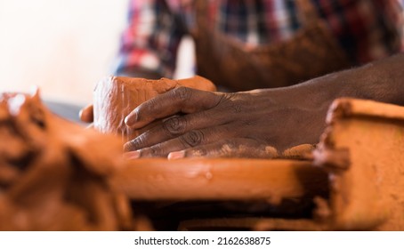 Close Up Of Hands Working On Pottery Wheel In Workshop