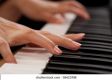 Close Up Of The Hands Of A Young Woman Playing Piano