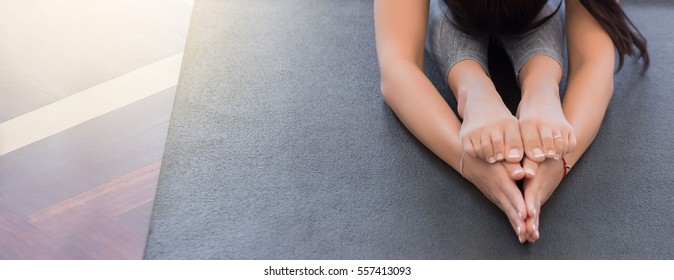 Close Up Of The Hands Of A Young Woman Practicing Yoga On A Black Mat, Copy Space On Left Area, Mockup.