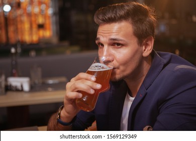 Close Up Of A Handsome Elegant Man Drinking Delicious Beer At The Pub