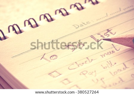 close up Handwritten to do list plan in a  small note book