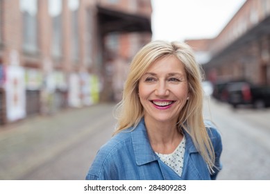 Close Up Happy Adult Woman With Long Blond Hair, Laughing While Walking At The City Street