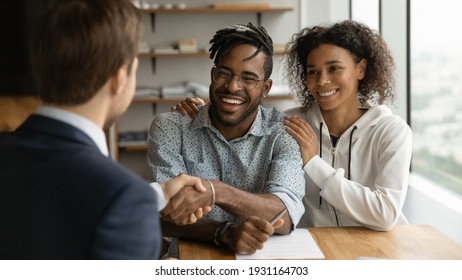 Close Up Happy African American Family And Manager Realtor Handshaking At Meeting, Family Purchasing New House, Taking Loan, Mortgage, Smiling Man And Financial Advisor Shaking Hands, Making Deal