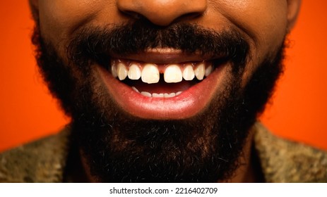 close up of happy and bearded african american man isolated on orange - Powered by Shutterstock