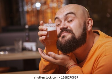 Close Up Of A Happy Bearded Man Cuddling With A Glass Of Beer. Cheerful Man Loving His Beer