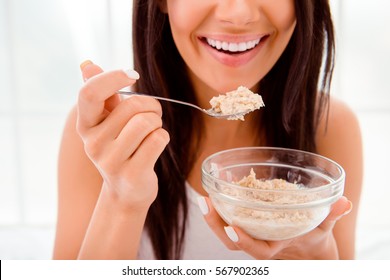 Close Up Of Happy Cheerful Woman Eating Porridge In Morning.