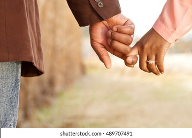 Close up of a happy couple holding hands.  Engagement. Love. - Powered by Shutterstock