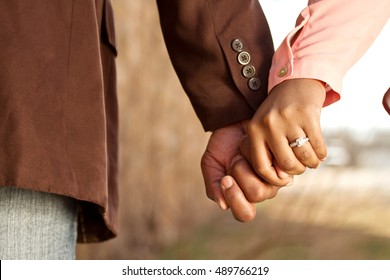 Close up of a happy couple holding hands.  Engagement. Love.