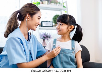 close up of happy girl and doctor on medical exam.ASian Female  doctor or nurse  Listening To Girls Chest With Stethoscope at home. - Powered by Shutterstock