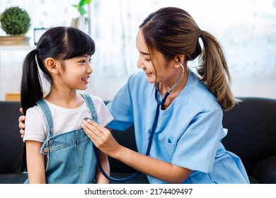 close up of happy girl and doctor on medical exam.ASian Female  doctor or nurse  Listening To Girls Chest With Stethoscope at home. - Powered by Shutterstock