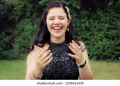 Close up of happy, laughing teenage girl in black sequin racerback prom dress