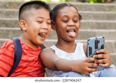 Close up of happy multiethnic children taking selfie stiking out the tongue. Use of technologies and social media by children - Powered by Shutterstock