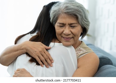 Close Up Happy Older Mature Mother Embracing Young Grownup Daughter With Kindly. Young Woman Carefully Takes Care Of Old Woman. Elderly Mum And Grownup Daughter Hugging Together At Home 