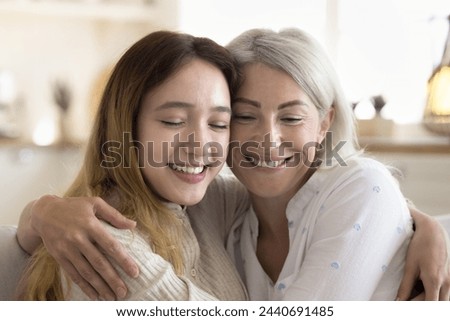 Close up of happy pre-teen girl and mature mother spend family leisure at home, hug, enjoy tender moment, good relationships, demonstrate support and warmth. Understanding, love, devotion, motherhood Stock photo © 