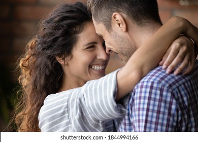 Close up of happy young Caucasian couple hug and cuddle enjoy tender close romantic moment together. Smiling millennial man and woman embrace show love and care in relationship. Marriage concept. - Powered by Shutterstock