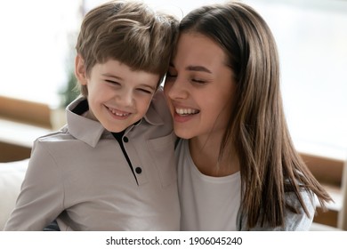 Close Up Of Happy Young Caucasian Mother Hold In Arms Hug Smiling Cute Little Son Enjoy Family Weekend At Home Together. Caring Mom Embrace Small Boy Child, Show Love, Have Tender Sweet Close Moment.