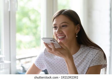 Close Up Of Happy Young Caucasian Woman Record Audio Message On Modern Smartphone, Talk On Loudspeaker On Gadget. Smiling Millennial Female Activate Digital Voice Assistant App On Cellphone.