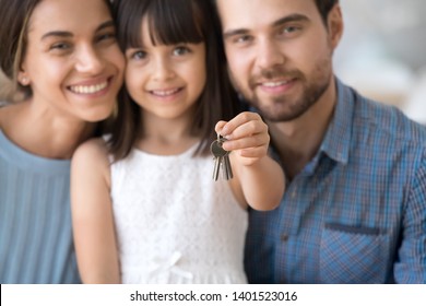 Close Up Of Happy Young Family With Preschooler Child Hold Keys Moving To New Apartment Together, Excited Millennial Parents With Little Daughter Buy First Own Home. Ownership, Relocation Concept