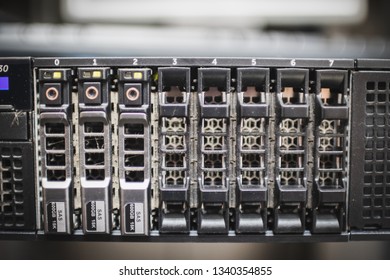 Close up of hard disk dock in front of a rack server in server room where hard drives are installed to store the information