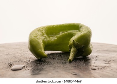 A Close Up Of A Hatch Green Chili Pepper In A Studio Setting.