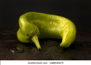 A Close Up Of A Hatch Green Chili Pepper In A Studio Setting.