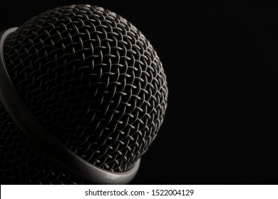 Close up head audio microphone in black background with copy space on the right. Macro shot. - Powered by Shutterstock