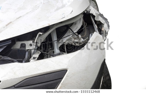 Close up head light of  white color car have\
damaged and broken by accident isolated on white background. Save\
with clipping path.