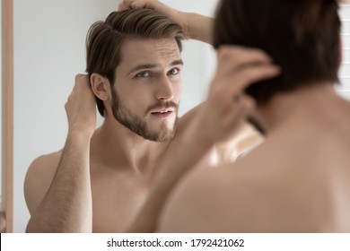 Close Up Head Shot Anxious Stressed Young Man Touching Head, Checking Hair, Looking In Mirror, Standing In Bathroom, Worried About Dandruff Or Hair Loss, Healthcare And Beauty Concept