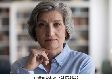 Close up head shot beautiful grey-haired woman touch chin with hand staring at camera, looks confident and serious, having elegant style, attractive appearance. Mature businesswoman portrait concept - Powered by Shutterstock