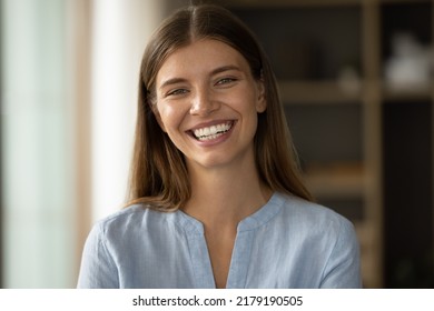 Close Up Head Shot Beautiful Woman With Natural Beauty, Wide Smile And Perfect Skin No Make Up Posing Indoor Staring At Camera Looks Self-assured. Portrait Of Gorgeous Young Independent Female Concept