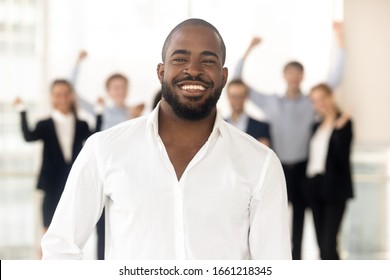 Close Up Head Shot Portrait Smiling Black Small Business Owner In Office. Happy African American Male Employee Ceo Looking At Camera, Headshot Diverse Confident Successful Guy Boss Or Manager At Work