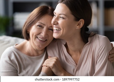 Close Up Head Shot Portrait Smiling Mature Mother And Grownup Daughter Cuddling, Family Enjoying Tender Moment, Happy Young Woman With Elderly Mum Hugging, Spending Leisure Time Together