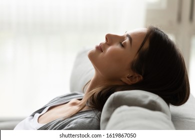 Close Up Head Shot Profile Peaceful Beautiful Woman Relaxing, Sleeping On Comfortable Couch At Home, Pretty Young Female Enjoying Rest, Weekend, Breathing Fresh Air, Meditating With Closed Eyes