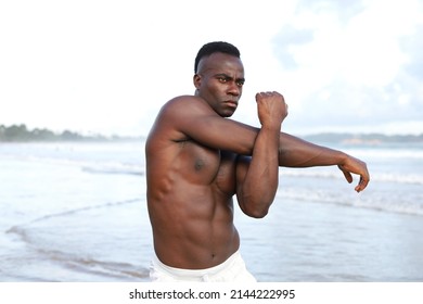 Close Up Head And Shoulders Portrait Of Young Attractive And Fit Black African American Man With Strong Muscular Body Posing Cool Model Attitude On The Beach