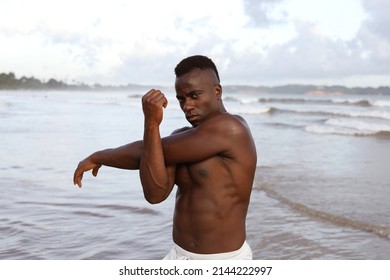 Close Up Head And Shoulders Portrait Of Young Attractive And Fit Black African American Man With Strong Muscular Body Posing Cool Model Attitude On The Beach