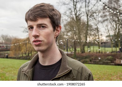 Close Up Head And Shoulders Of A Young Man In His Late Teens Or Early Twenties Walking In A Park.