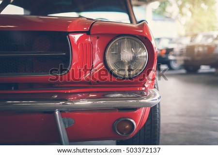 Close up headlight of red Retro classic car, Vintage tone