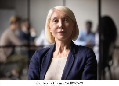 Close Up Headshot Portrait Of Mature Businesswoman Look At Camera Showing Confidence, Middle-aged Focused Positive Female CEO Or Boss, Woman Employee Posing For Picture In Office, Leadership Concept