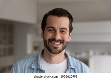 Close up headshot portrait of smiling 30s Caucasian man look at camera posing in own flat or apartment. Profile picture of happy 20s male renter or tenant in new home. Real estate, rental concept.
