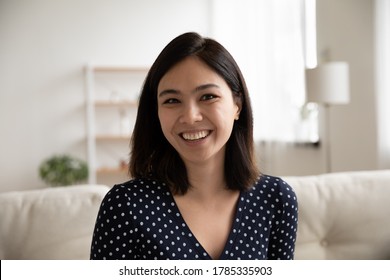 Close Up Headshot Portrait Of Smiling Vietnamese Young Woman Look At Camera Talk On Video Call. Profile Picture Of Happy Millennial Asian Female Engaged In Webcam Conference Or Virtual Event At Home.