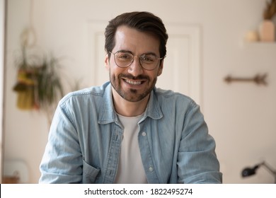 Close up headshot screen view of smiling Caucasian man in glasses have webcam conversation online. Portrait of happy young male in spectacles talk speak on video call. Communication concept. - Shutterstock ID 1822495274