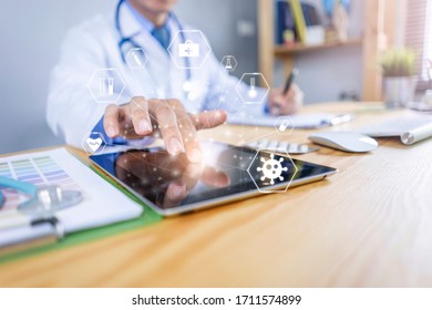 Close Up Of Healthcare And Medical Doctor Using Smart Tablet Device And Writing On Notebook For Research Development On Coronavirus And Diagnosis On Patient Health Concept, In Hospital Office Room