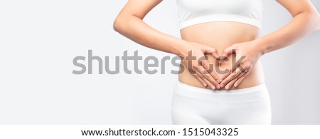 Close up healthy Stomach Ache woman hands made heart on belly isolated on white background banner size. gut health care digestion concept. 
Stomach health woman .