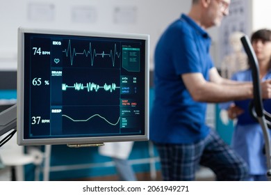 Close up of heart rate monitor measuring pulse while patient doing exercise for physical recovery. Senior man using stationary equipment to recover with physiotherapy and gymnastics. - Powered by Shutterstock