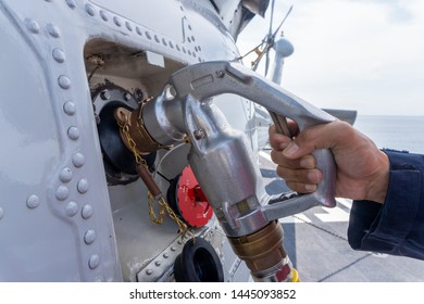 Close Up Of The Helicopter Refueling  Operation Onboard The Navy Ship While The Ship Is Underway At Sea