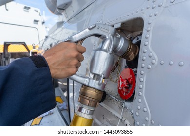 Close Up Of The Helicopter Refueling  Operation Onboard The Navy Ship While The Ship Is Underway At Sea